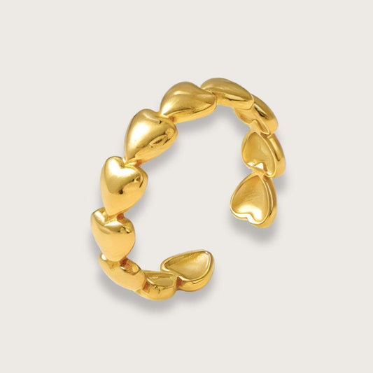 Guldbelagt hjertering i enkelt design. Amélies hjerteformede led danner et sødt lille bånd. Vandfast og slidstærk. Oplagt gaveidé til veninde, mor eller søster.  Amélie hjertering i guldbelagt rustfrit stål · Vandfaste smykker