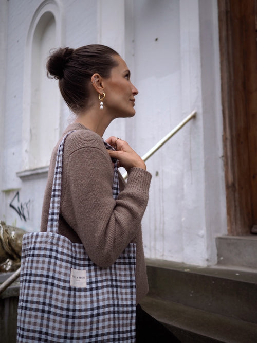 Lille tote bag med klassiske tern i sort og beige nuancer. Designet og syet i Spanien.

Nice er en skøn lille tote bag i tykt jacquardvævet stof.

Tasken er lavet til at følge dig gennem dagen – fra skole til café – og fungerer perfekt som både skoletaske, hverdagstaske og som en ekstra lille taske, der nemt kan pakkes væk og findes frem, hvis dagen byder på shopping eller den lidt mere kedelige form for indkøb.

Med en størrelse på 36 x 39 cm rummer den de fleste laptops