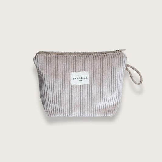 Lille toilettaske eller makeuptaske med lynlås øverst og beige snorhåndtag på siden. Lavet af tykt beige fløjlstof. Fra spanske De la Mur. Unisex. Toilettaske til mænd. Toilettaske til kvinder.