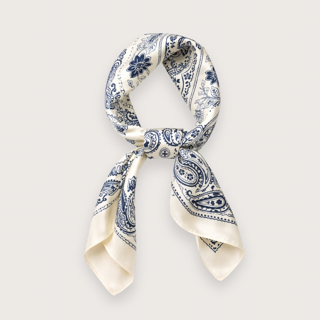 Lila satintørklædet har et klassisk hvidt paisleymønster på en smuk marineblå baggrund.

Farven er let og klar, mens satinen tilfører en diskret glans, som minder om silke og falder smukt, når tørklædet bindes. Et kvadratisk tørklæde med et tidløst udtryk.

Det hvide satintørklæde er særligt velegnet til forår og sommer, hvor lette materialer og klare farver gør en forskel i hverdagen. 

hvidt satintoerklaede med blåt paisleymoenster silketoerklaede i satin i klassisk stil kvadratisk toerklaede til kvinder